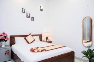 Postel nebo postele na pokoji v ubytování Tuấn An Hotel