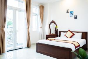 Postel nebo postele na pokoji v ubytování Tuấn An Hotel