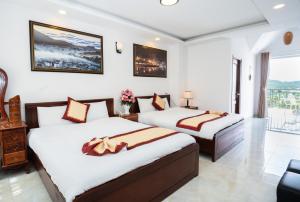 Postel nebo postele na pokoji v ubytování Tuấn An Hotel