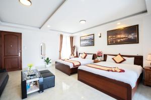 Postel nebo postele na pokoji v ubytování Tuấn An Hotel