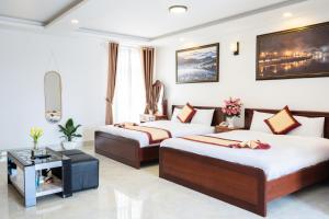 Postel nebo postele na pokoji v ubytování Tuấn An Hotel