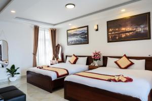 Postel nebo postele na pokoji v ubytování Tuấn An Hotel