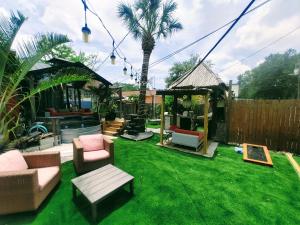 a backyard with green grass and furniture and a fence at World Solo Travel's Welcomed At St Pete Home in St. Petersburg
