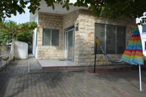 a house with a colorful umbrella in front of it at Casa frente al mar - Internet - SmartTV - Netflix - DirectTV in Tonsupa