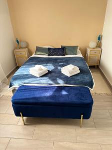 a bedroom with a large bed with blue sheets at Villa Belle Ile en Mer in Capesterre-de-Marie-Galante