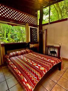 a bedroom with a bed and a large window at Hacienda Sarah in Nosara