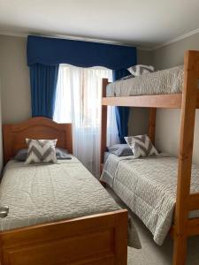 a bedroom with two bunk beds and a window at Casa Amoblada Santa Sofia in Concepción