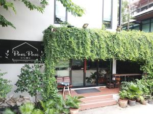 a building with ivy growing on the side of it at PomPom Home in Bangkok
