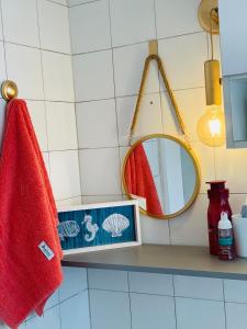 a bathroom with a red towel and a mirror at Apartamento Auge da Bahia in Salvador
