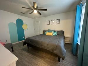 a bedroom with a bed and a ceiling fan at Coral Sky in Pensacola