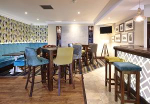 a restaurant with tables and chairs and a bar at The Wishing Well in Selby