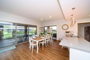 a kitchen and dining room with a table and chairs at Family-Friendly Gorgeous Farm House (TF195223) in Dixons Creek