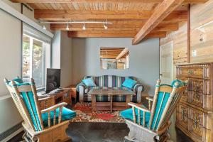 a living room with chairs and a table and a couch at Coppertop- Firepit-Skyline Views in Rapid City