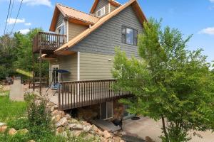 a house with a porch and a balcony at Coppertop- Firepit-Skyline Views in Rapid City
