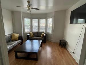 a living room with a couch and a coffee table at A comfortable home for you in Trenton