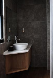 a bathroom with a sink and a mirror at Here It's Home in Green Island