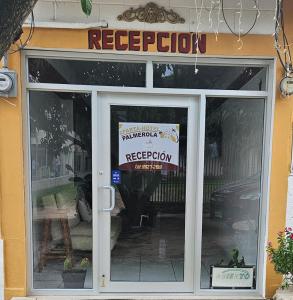 a door to a restaurant with a sign on it at Aparta Hotel Palmerola in Comayagua