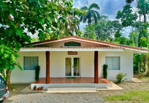 a small house with a driveway in front of it at Casa Martin Cahuita Charming Spanish Home in Cahuita