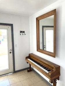 a mirror and a piano in a room at Departamento Casa Blanca Paquimé in Nuevo Casas Grandes