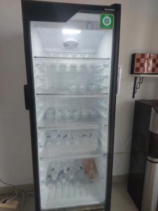 an empty refrigerator with its door open in a room at HAPDESKO HOMESTAY in Batam Center