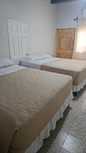 Habitación con 3 camas en una habitación en Aparta Hotel Palmerola, en Comayagua