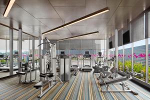 a gym with cardio equipment in a building at Aloft Kuala Lumpur Sentral in Kuala Lumpur