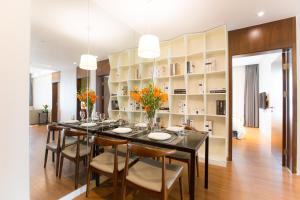 a dining room with a long table and chairs at Modena By Fraser New District Wuxi in Wuxi