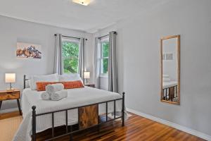 a bedroom with a bed with two towels on it at Mid-Century Magic - HUGE Space in Rapid City