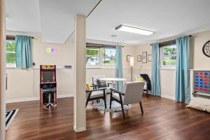 a living room with a dining room table and a game room at Mid-Century Magic - HUGE Space in Rapid City