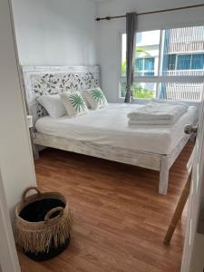 a bedroom with a large bed with a window at Bohemian Bali style in Hua Hin