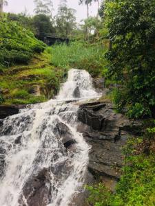 a waterfall on the side of a river at Ansi Villa in Nanu Oya