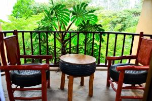 een veranda met 2 stoelen en een tafel en 2 stoelen bij Merinja Guest House in Naivasha