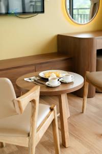 a wooden table with a plate of food on it at CAO BANG ECO HOUSE in Cao Bằng