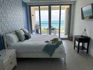 a bedroom with a bed with a view of the ocean at Azure 515 Aruba Vacation Sunset Breeze in Palm-Eagle Beach +30 photos