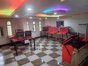 a room with red chairs on a checkered floor at Bestex Group of Hotels in Makkah