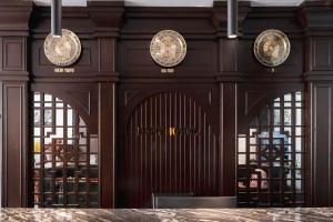 a wooden wall with three clocks on it at Navy Hotel Hà Nội in Hanoi