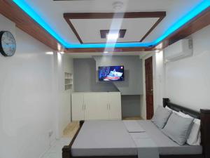 a room with a bed and a tv on the ceiling at Fabuluz Luxury at Princess Place in Malolos
