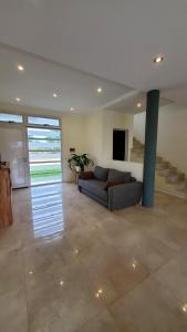 a living room with a couch and a staircase at Duplex solar in Federación