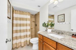 a bathroom with a sink and a toilet at Luxurious Golf Retreat Villa in PGA National! in Palm Beach Gardens +31 photos