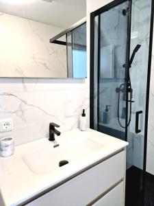 a bathroom with a sink and a shower at Apartments Tadic in Omišalj