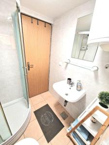 a bathroom with a sink and a shower at Apartments Tadic in Omišalj +23 photos