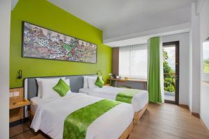 Letto o letti in una camera di RV Hotel Gianyar