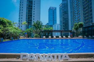 a large swimming pool in a city with tall buildings at Sentosa Hotel Shenzhen Feicui Branch, Enjoy tropical swimming pools and high-class fitness club in Shenzhen +82 photos