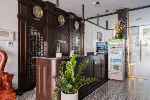 a room with a counter with clocks on the wall at Navy Hotel Hà Nội in Hanoi