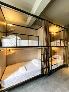 two bunk beds are in a room with at Zenz Hotel in Kulai