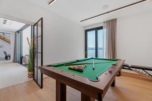 a pool table in a living room with at Villa Loma, Brzet, Omiš in Omiš