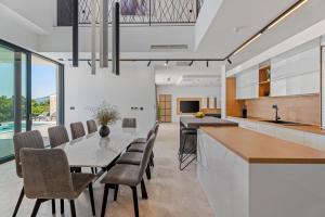 a kitchen and dining room with a table and chairs at Villa Loma, Brzet, Omiš in Omiš
