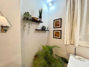 a room with a desk and a plant on the wall at Arora Bhavan Studio 1A, Khar West by Connekt Homes in Mumbai
