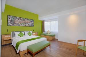 Letto o letti in una camera di RV Hotel Gianyar
