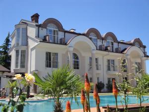 a large house with a swimming pool in front of it at Aleksandar Villa & Spa in Ohrid